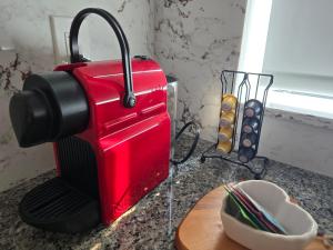 a red toaster sitting on top of a counter at GGP Boutique Townhome in Vaughan