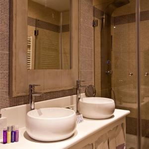 
a bathroom with two sinks and a large mirror at Hotel El Ciervo in Vielha
