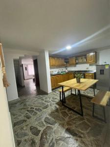 a kitchen with a table in the middle of it at Hermoso apartamento en guayabal in Medellín