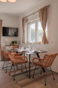 a dining room with a table with wine glasses on it at VIRCATION Apartments in Vir