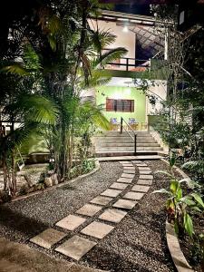 a stone walkway in front of a building with stairs at Casa em Alter do chão - lago verde in Alter do Chao
