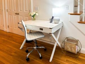 a white desk with a chair and a lamp at Modern Townhome,boston Vacation,2 Bath,pkg,deck in Brookline