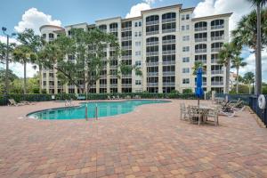 a large building with a pool and tables and chairs at 3br L Pool Family & Corporate Travel Sleeps 6 in Palm Coast