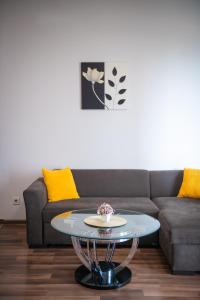 a living room with a couch and a table at Cozy stay rentals- cozy & sweet 1 BR apartment in Tbilisi with city & mountains view in Tbilisi City