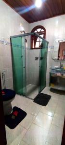 a bathroom with a shower and a toilet and a sink at Casa temporada Monsuaba in Angra dos Reis +11 photos