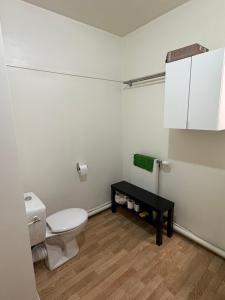 a bathroom with a toilet and a black table at Bon77 in Noisiel