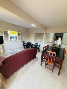 a living room with a couch and a table and chairs at Pousada Durma Bem in Tianguá