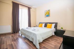 a bedroom with a large bed with towels on it at Cozy stay rentals- cozy & sweet 1 BR apartment in Tbilisi with city & mountains view in Tbilisi City