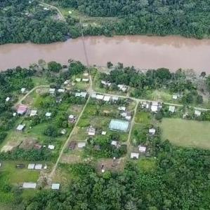 an aerial view of a farm next to a river at San Pablo de Katëtsiaya 