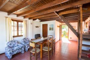 a living room with a dining room table and chairs at Cabañas Rio Hermoso in Cerro Negro