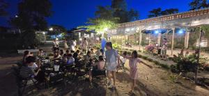 a group of people sitting in chairs at an event at Tháng Tư Glamping in Ha Tien