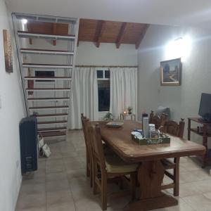 a dining room with a table and a spiral staircase at Renacer in Playa Unión
