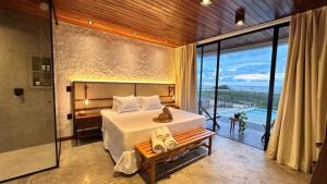 a bedroom with a bed and a view of the ocean at Vila Cangalha in Camocim +141 photos