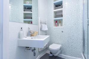 a bathroom with a white sink and a toilet at Bull Ring Apartment City Views Free Parking in Birmingham