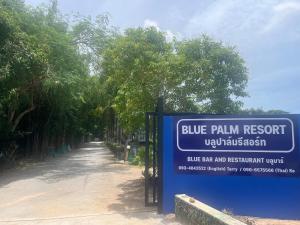 a blue palm resort sign next to a road at Blue Palm Resort in Bang Sare +1 photo
