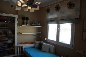 a bedroom with a blue bed and a window at Infinite blue Horizon Elegance Hospitality in Epanomi