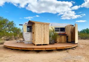 a tiny house on a wooden deck in the desert at The Island in Tucson in Tucson