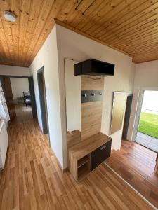 a living room with wooden floors and a wooden ceiling at Ferienhaus Rafaela mit Privatstrand in Ledenitzen