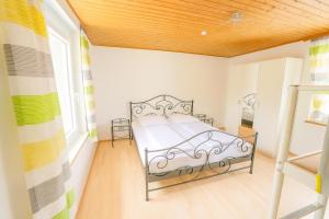 a bedroom with a bed in a room at Ferienhaus Rafaela mit Privatstrand in Ledenitzen +2 photos