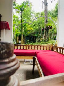 a room with a red blanket on a bench at Motel Vintage Beliatta in Beliatta +35 photos