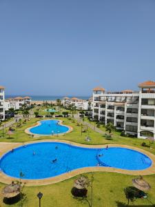 an image of a large swimming pool in a resort at Résidences Nawal in Asilah