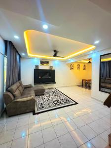a living room with a couch and a tv at Ciksiti homestay landed 05 in Kajang