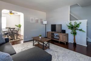 a living room with a couch and a tv and a table at Relaxed 2BR Apt in Moraine with Office Space and Washer & Dryer in Moraine