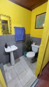 a bathroom with a sink and a toilet and a mirror at Habitación estilo vintage cerca de La Merced in Antigua Guatemala