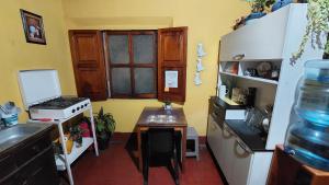 a kitchen with a table and a stove and a sink at Habitación estilo vintage cerca de La Merced in Antigua Guatemala +13 photos