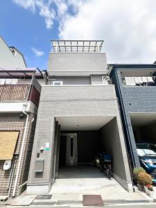 a garage with a car parked inside of it at Arashi Kohama Direct to Namba Kohama Station 5 minutes Cozy Mansion in Wada