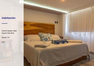 a bedroom with a bed with a wooden headboard at Apartment with Pool Acapulco 1 Bedroom in Acapulco +23 photos