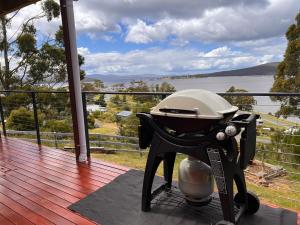 a grill on a deck with a view of the water at Beyond the View in Dover