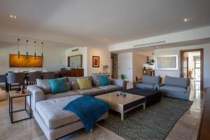 a living room with a couch and a table at 3BR Beachfront Luxury Condo w/ Great Features in Cancún