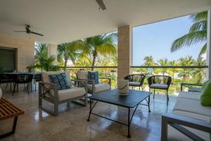 a living room with chairs and a table at 3BR Beachfront Luxury Condo w/ Great Features in Cancún