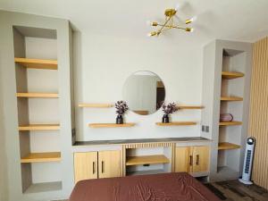 a bedroom with wooden shelves and a mirror at Casa SAMA 10 in Oaxaca City