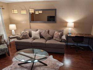 a living room with a couch and a glass table at STADIUM LUXURY - CONDO for 4 STEPS AWAY FROM SOFI in Inglewood