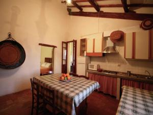 a kitchen with a table with a bowl of fruit on it at Cottage with Lake Views in San Savino +31 photos