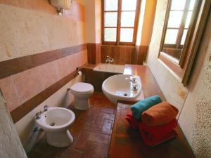 a bathroom with a sink and a toilet and a bidet at Cottage with Lake Views in San Savino