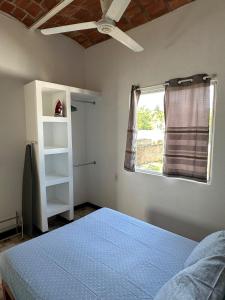 a bedroom with a blue bed and a window at Casa Arena in Lo de Marcos +28 photos