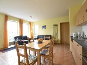 a kitchen and dining room with a table and chairs at Ferienhaus in Zierow in Zierow +19 photos