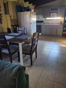 a kitchen with a table and chairs and a refrigerator at Casa Cinthya&Felipe in San Felipe +3 photos