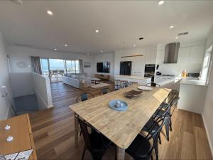 a kitchen and dining room with a large wooden table at Sea Escape in Point Turton