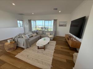 a living room with a couch and a table at Sea Escape in Point Turton