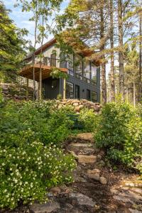 a house on top of a hill with trees at Tallens Stuga Luxury Cabin of the Pines in Lutsen