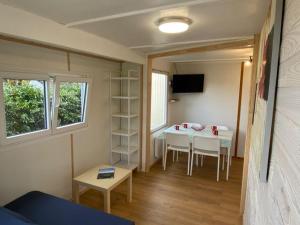a tiny house with a table and chairs in a room at Chalet Cozy avec Terrasse - 2 Chambres - API-1-52-340 in Gurmençon