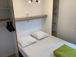 a small room with a bed and a shelf at Chalet Cozy avec Terrasse - 2 Chambres - API-1-52-340 in Gurmençon