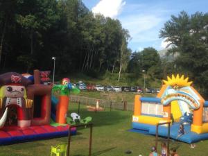 a playground with different types of play equipment in a park at Mobil-home 3 chambres avec terrasse à Valbonnais - API-1-52-473 in Valbonnais