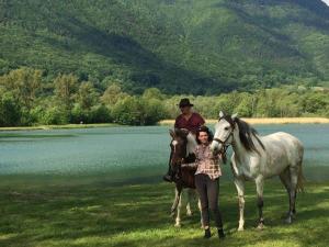 a man and a woman standing next to a horse at Mobil-home 3 chambres avec terrasse à Valbonnais - API-1-52-473 in Valbonnais