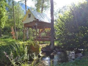 a tree house in the middle of a stream at Mobil-home 3 chambres avec terrasse à Valbonnais - API-1-52-473 in Valbonnais