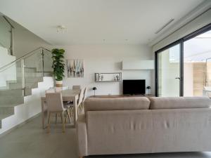 a living room with a couch and a table at Villa in Rojales with Pool near Coast in Rojales